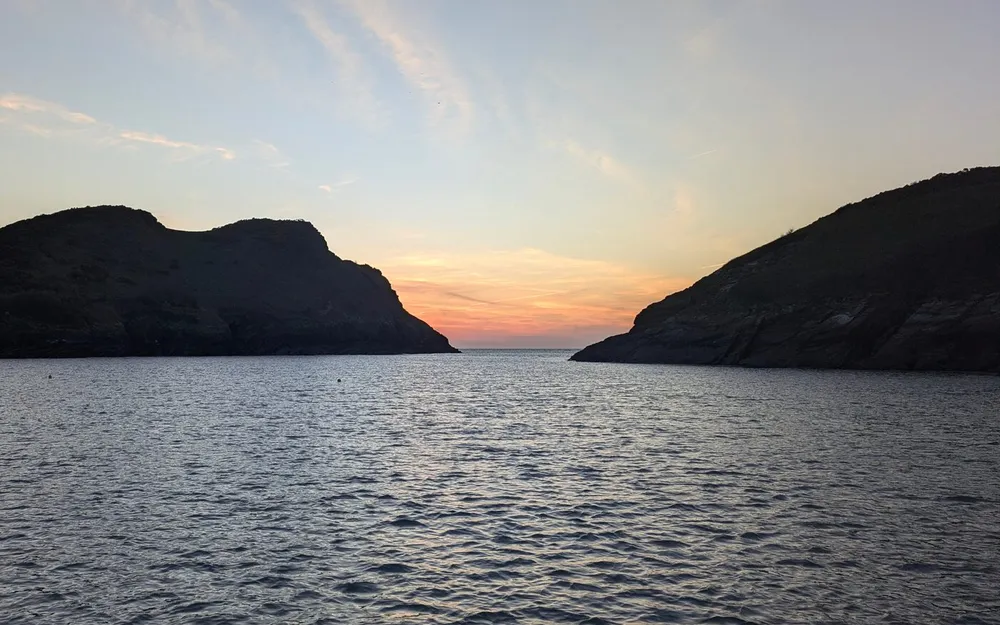 A narrow harbour entrance at dusk